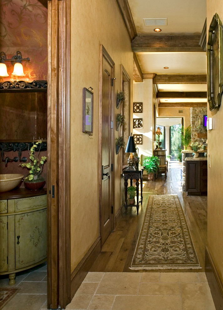 Inspiration for a mid-sized mediterranean dark wood floor and brown floor hallway remodel in Miami with beige walls