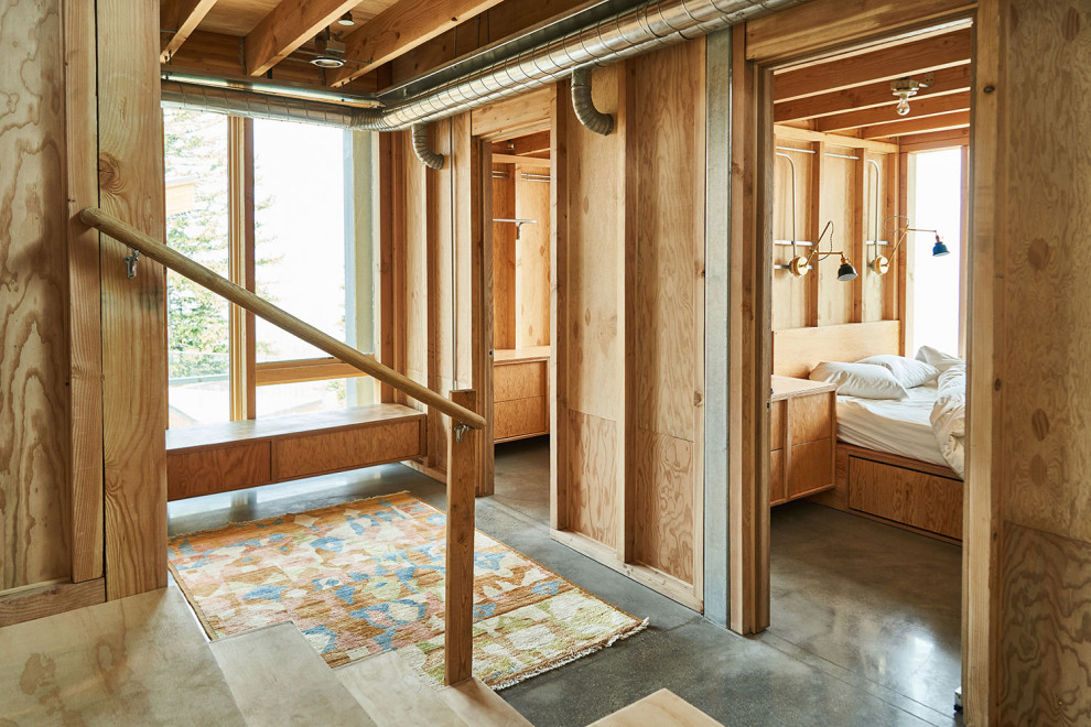 Ejemplo de recibidores y pasillos minimalistas con suelo de cemento y madera