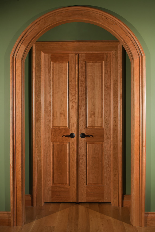 Hallway - large traditional medium tone wood floor and beige floor hallway idea in Detroit with green walls