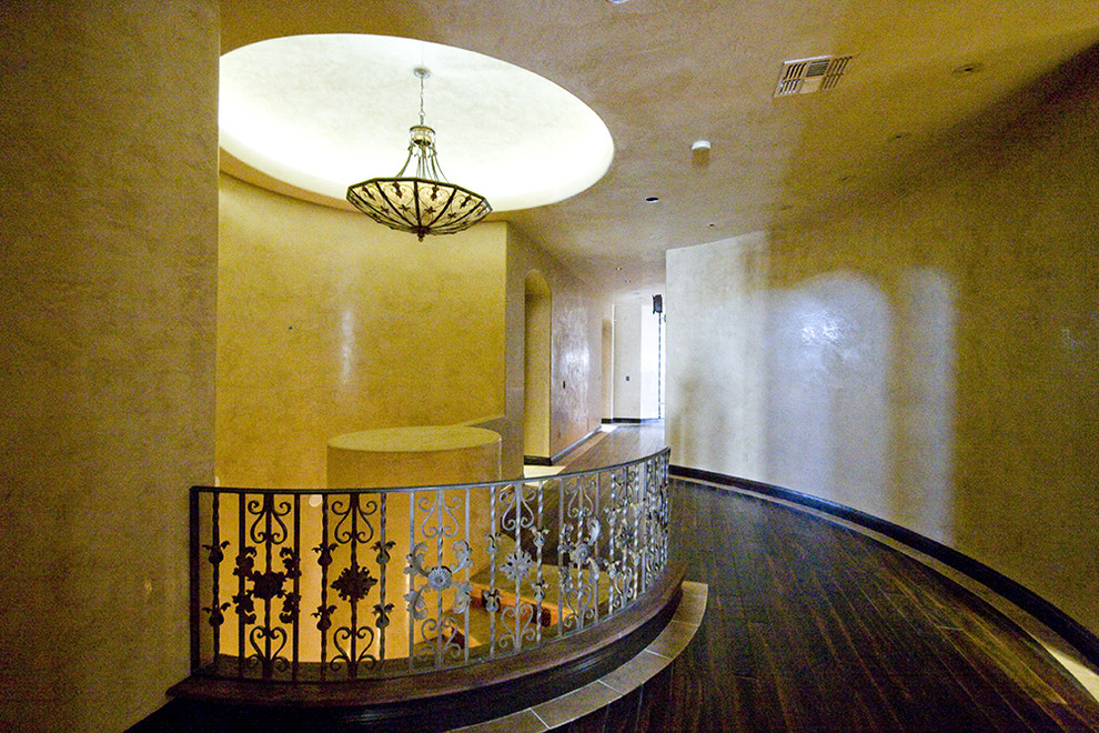 Inspiration for a large timeless dark wood floor hallway remodel in Las Vegas with beige walls