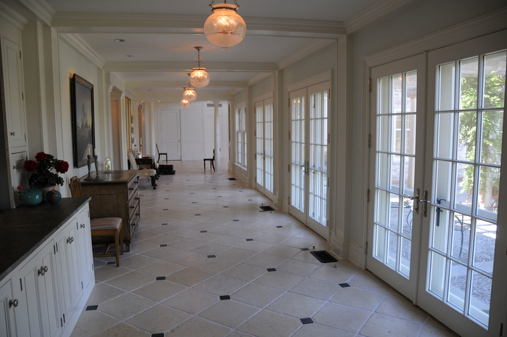 Inspiration for a large timeless limestone floor hallway remodel in New York with white walls