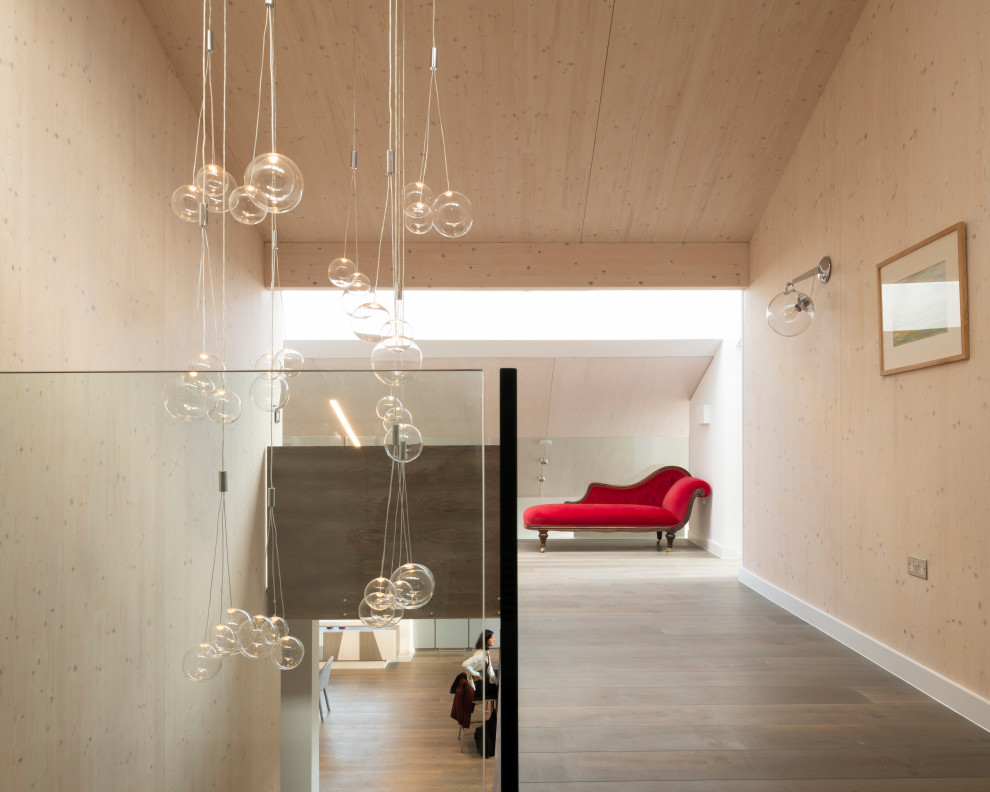 Hallway - contemporary medium tone wood floor, brown floor, vaulted ceiling, wood ceiling and wood wall hallway idea in London with beige walls
