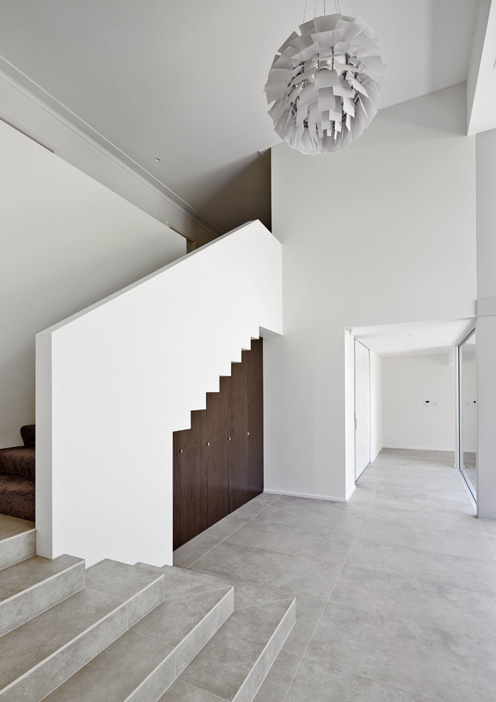 Example of a minimalist hallway design in Sydney with white walls