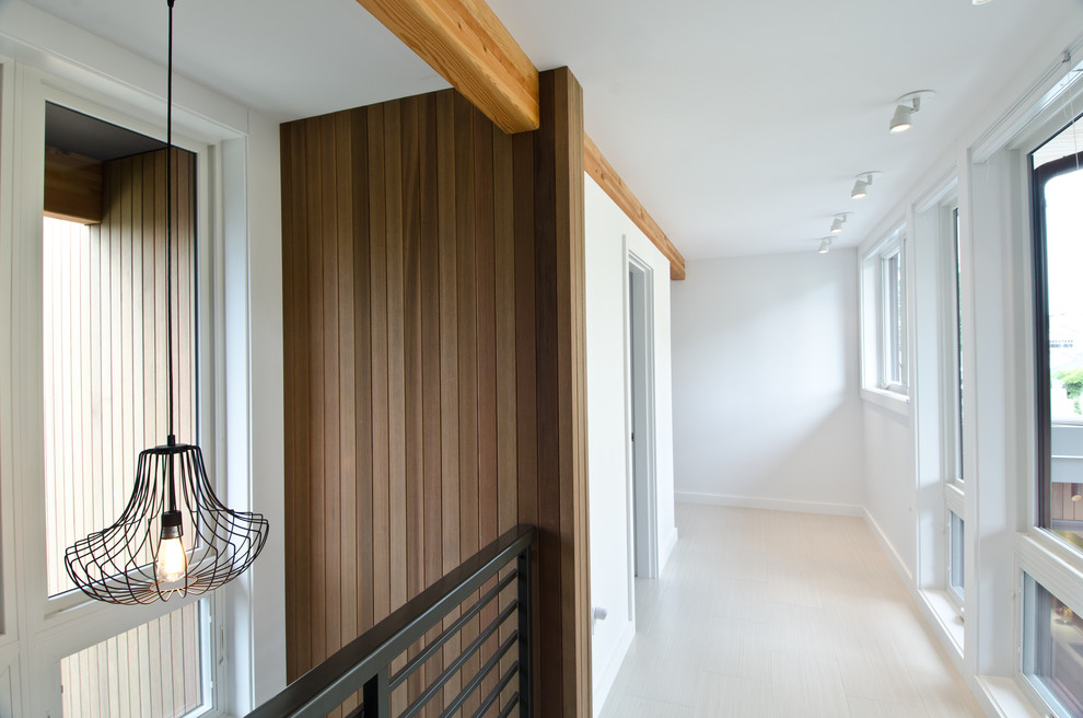 Inspiration for a contemporary hallway remodel in Seattle with white walls