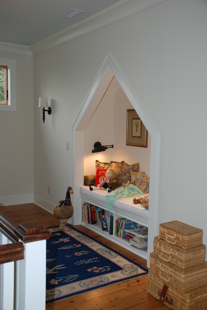 Elegant medium tone wood floor hallway photo in Charleston with white walls