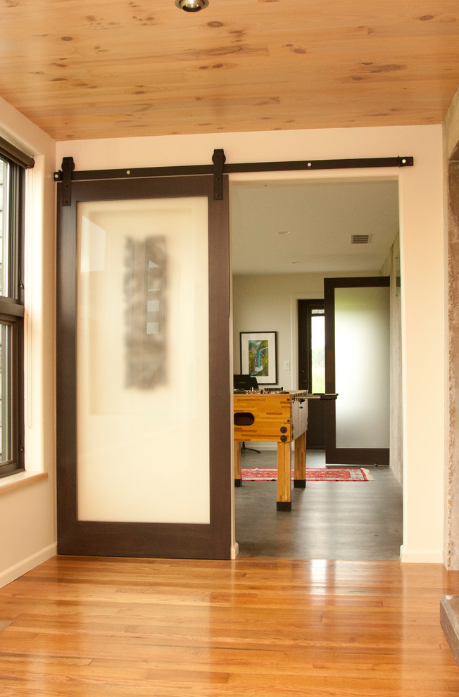 Example of a mid-sized minimalist concrete floor and gray floor hallway design in Other with white walls