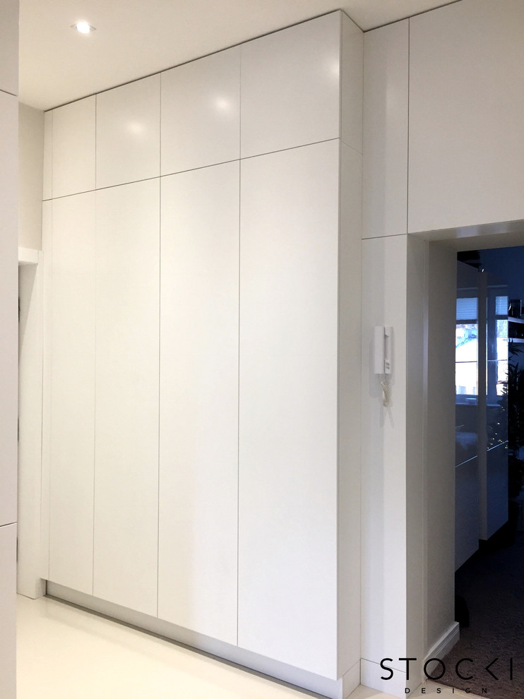 Idées déco pour un petit couloir moderne avec un mur blanc et un sol blanc.