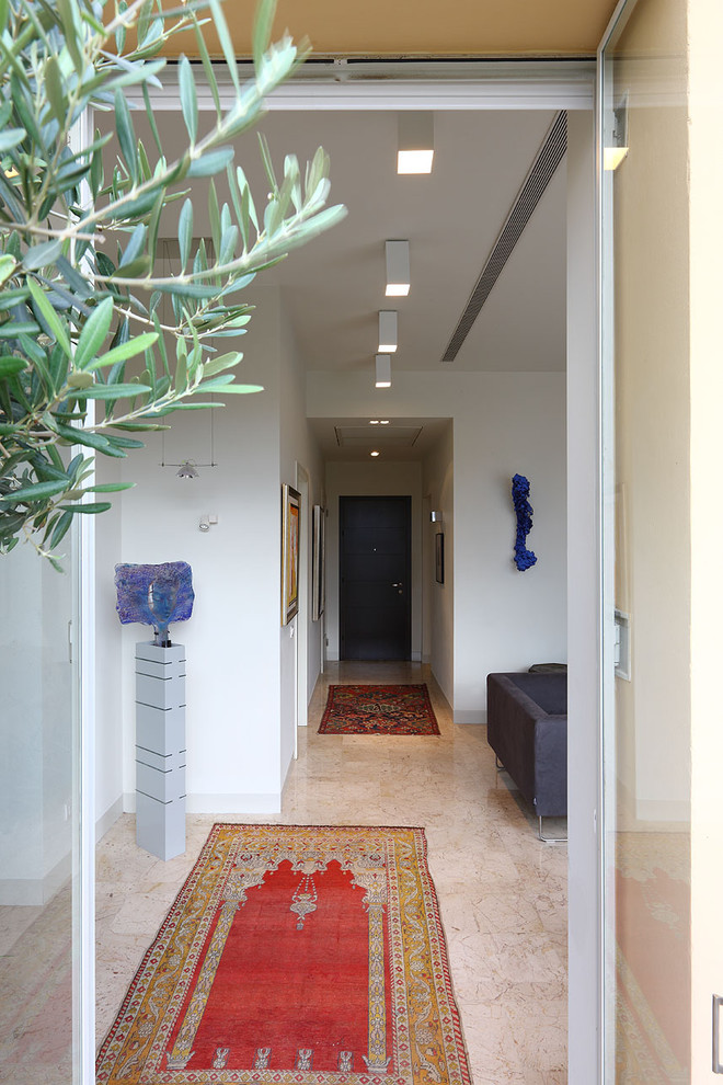 Idee per un ingresso o corridoio minimalista di medie dimensioni con pareti bianche e pavimento in pietra calcarea