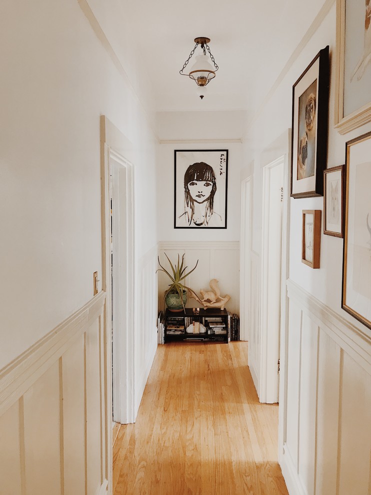 Cottage chic medium tone wood floor and brown floor hallway photo in San Francisco with white walls