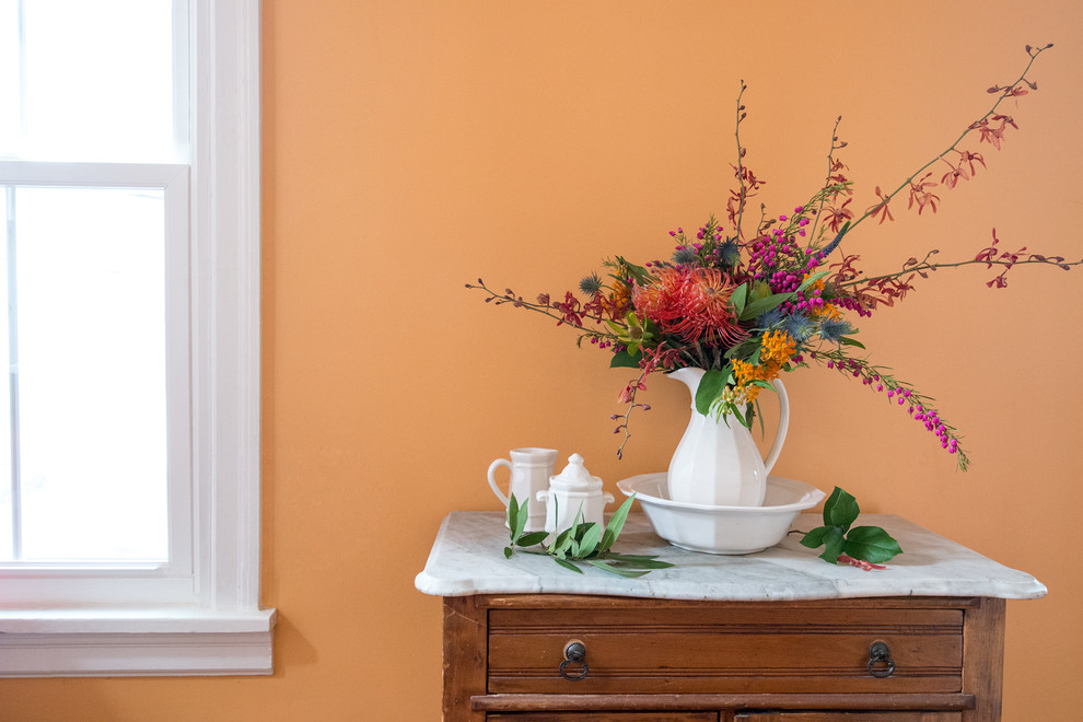 Kleiner Landhausstil Flur mit oranger Wandfarbe und braunem Holzboden in Philadelphia
