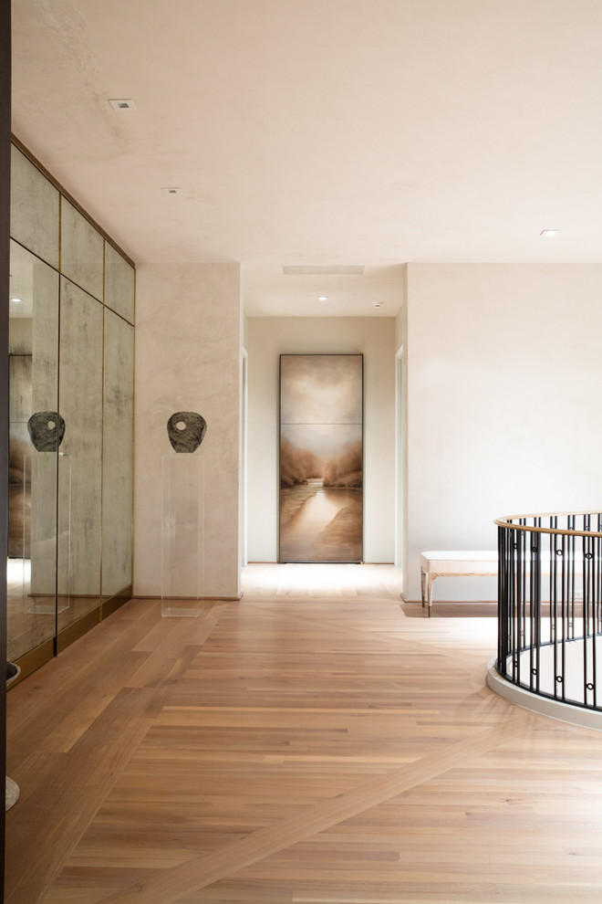 Hallway - large traditional medium tone wood floor and beige floor hallway idea in Other with beige walls