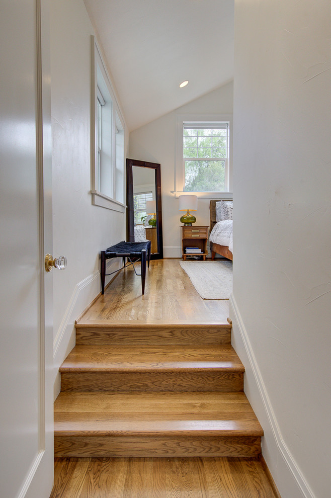 Mid-sized mid-century modern medium tone wood floor and brown floor hallway photo in Portland with white walls