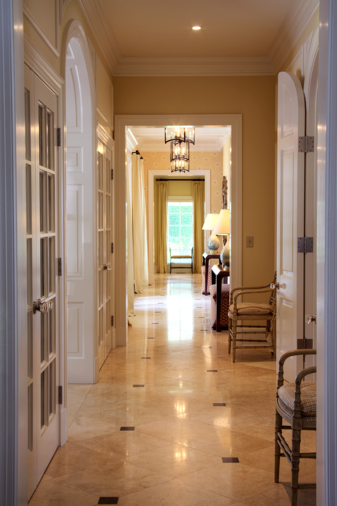 Example of a mid-sized classic limestone floor hallway design in Jacksonville with beige walls
