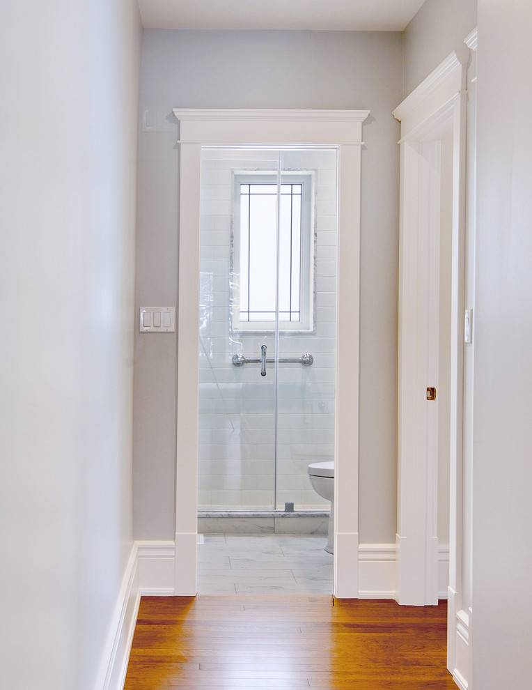 Hallway - small victorian medium tone wood floor hallway idea in Toronto with gray walls