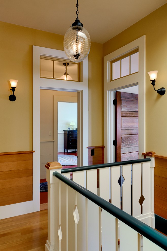 Example of a mountain style medium tone wood floor hallway design in Burlington with beige walls