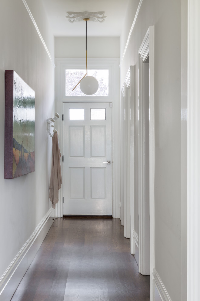 Mid-sized minimalist dark wood floor hallway photo in San Francisco with beige walls