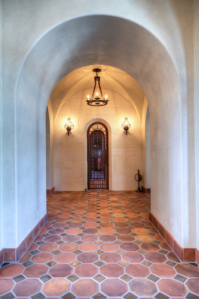 На фото: коридор в средиземноморском стиле с полом из терракотовой плитки с