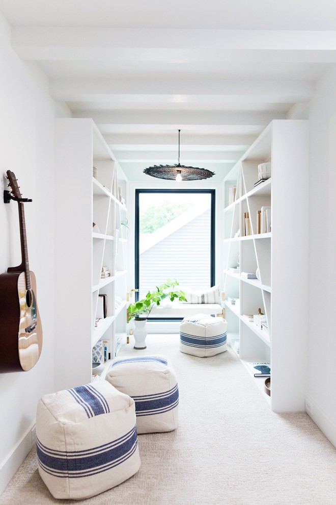Example of a danish carpeted and beige floor hallway design in Grand Rapids with white walls