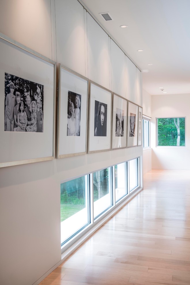 Minimalist light wood floor and beige floor hallway photo in Indianapolis with white walls