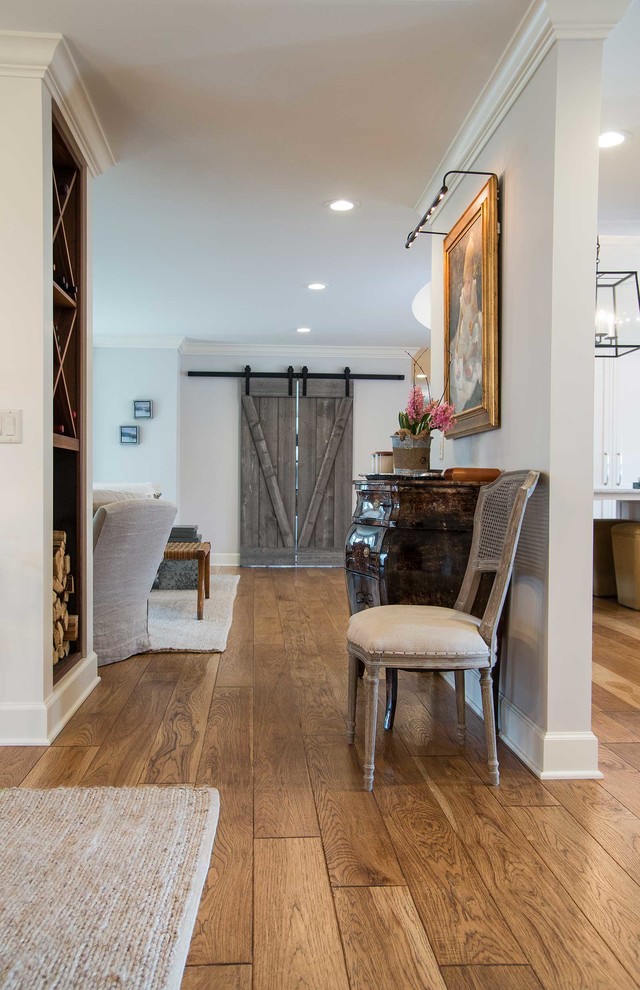 Large elegant medium tone wood floor and brown floor hallway photo in Other with white walls