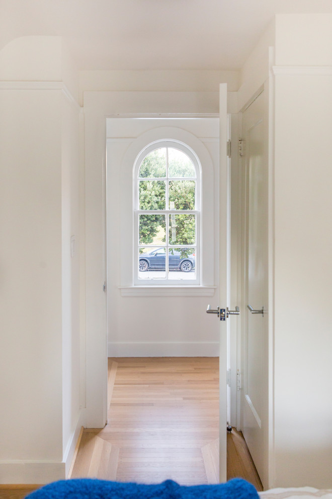Example of a trendy light wood floor hallway design in San Francisco with white walls