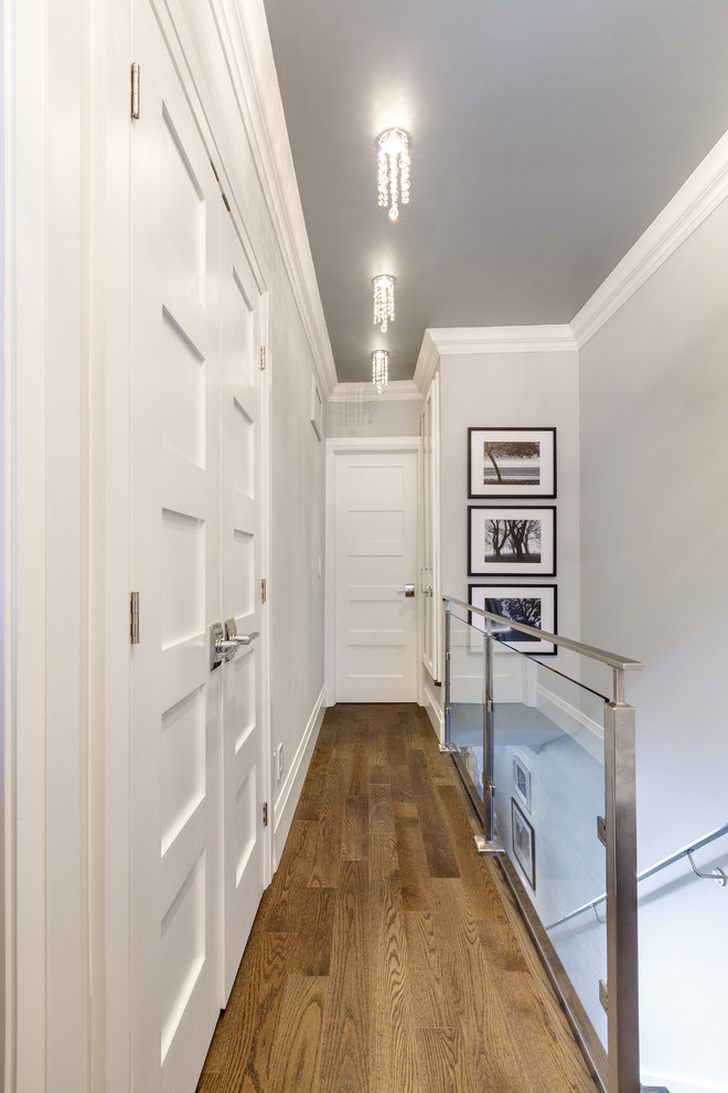 Hallway - small contemporary medium tone wood floor hallway idea in Other with gray walls