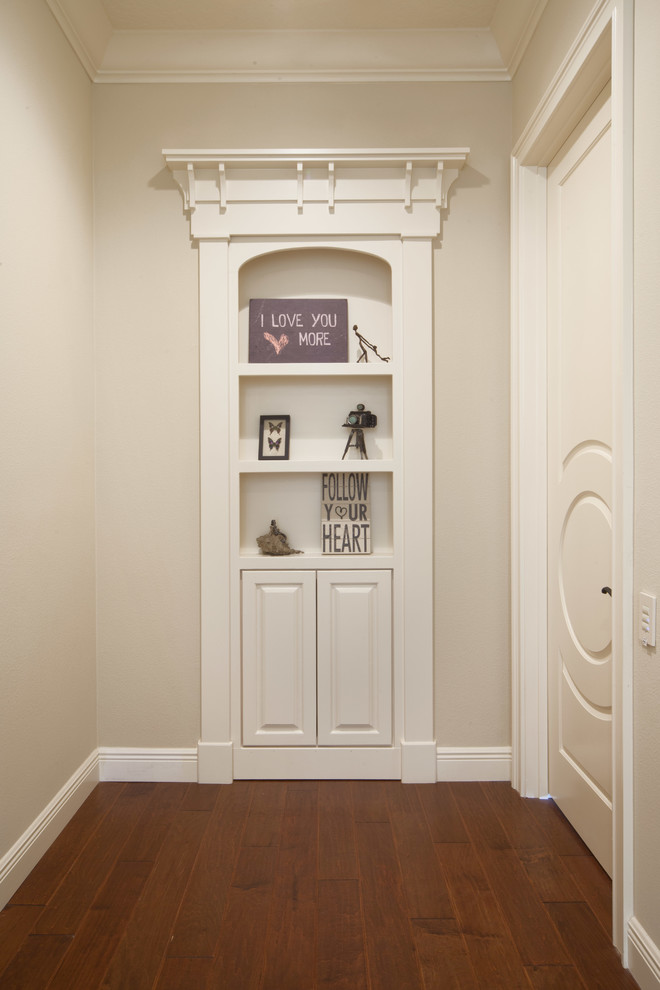 Hallway - mid-sized transitional medium tone wood floor hallway idea in Orlando with beige walls