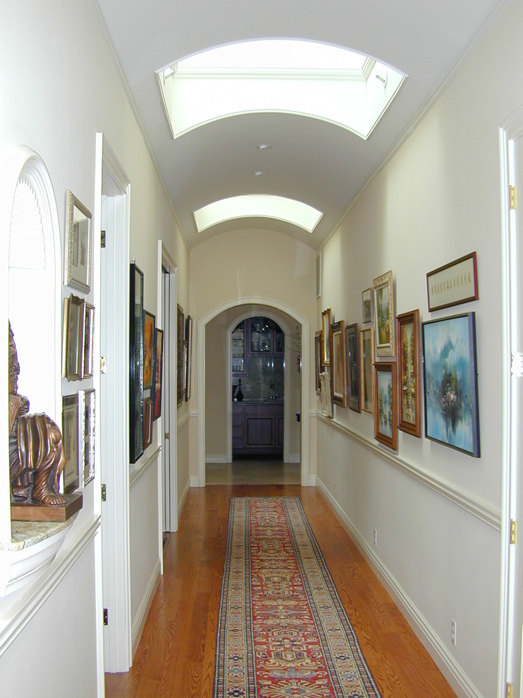 Large elegant medium tone wood floor and beige floor hallway photo in San Francisco with gray walls