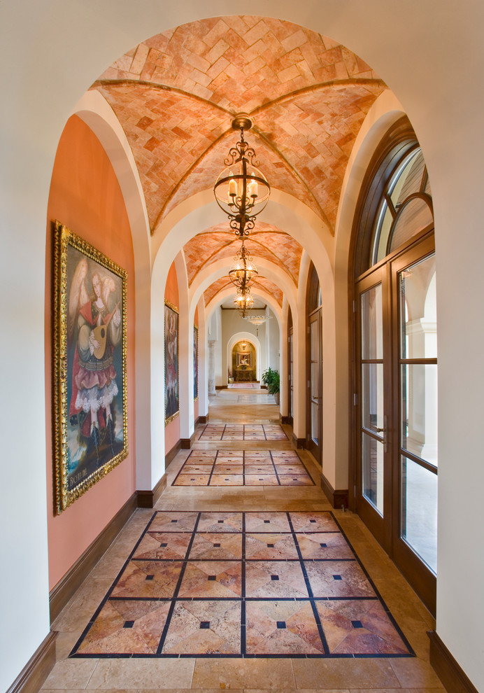 Example of a tuscan hallway design in Austin with orange walls