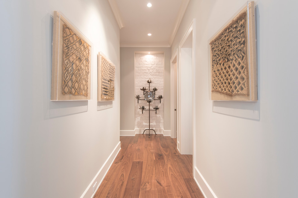 Hallway - large tropical medium tone wood floor hallway idea in Tampa with blue walls