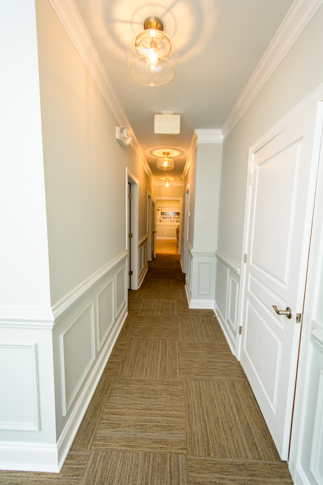 Mid-sized cottage carpeted and brown floor hallway photo in Raleigh with gray walls