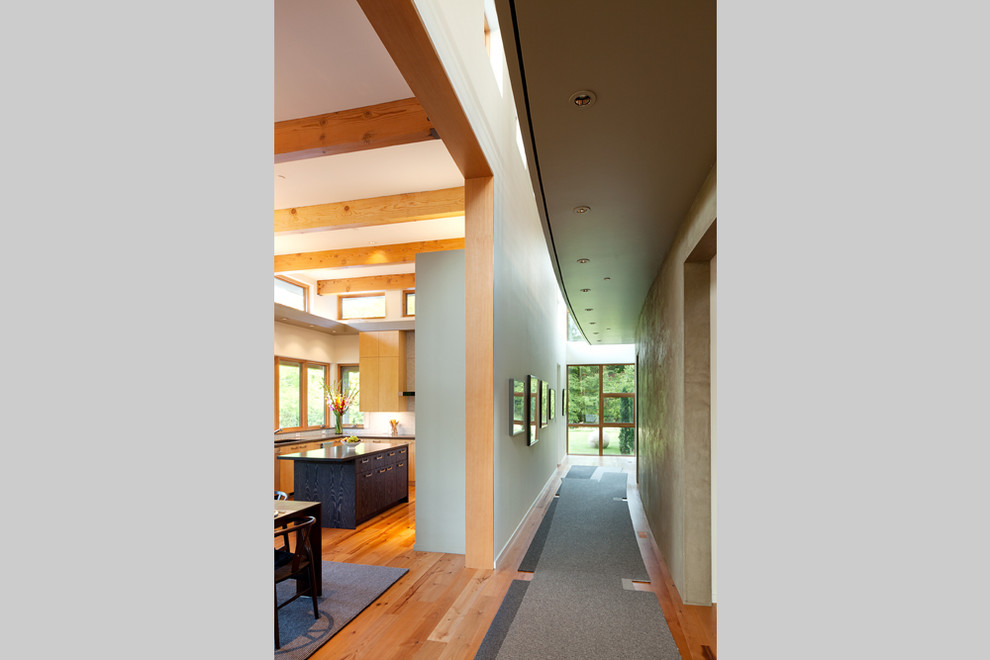 Example of a trendy medium tone wood floor hallway design in Portland with gray walls