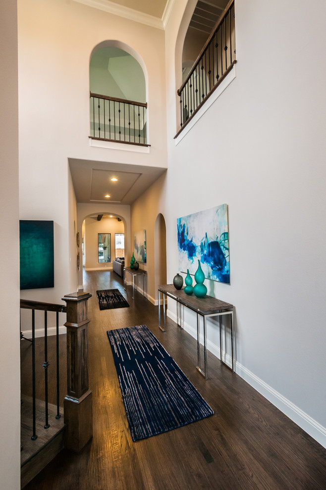 Hallway - mid-sized contemporary dark wood floor and brown floor hallway idea in Dallas with beige walls