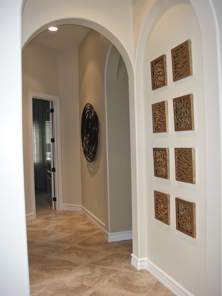 Example of a mid-sized island style beige floor hallway design in Miami with white walls