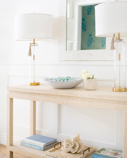 entryway console with glass lamp shades and gold accents