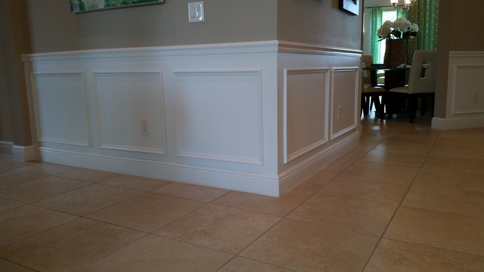 Example of a mid-sized classic ceramic tile and beige floor hallway design in Tampa with brown walls