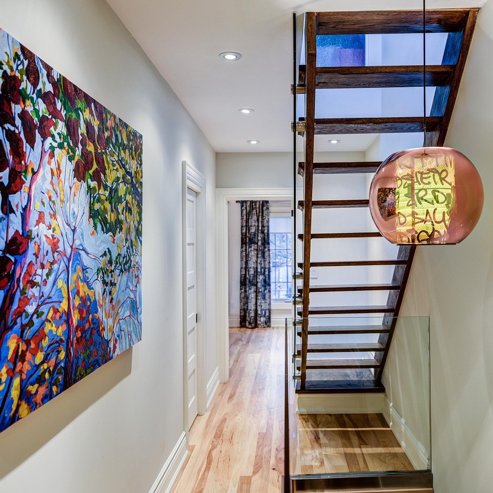 Hallway - mid-sized contemporary medium tone wood floor and brown floor hallway idea in Toronto with gray walls