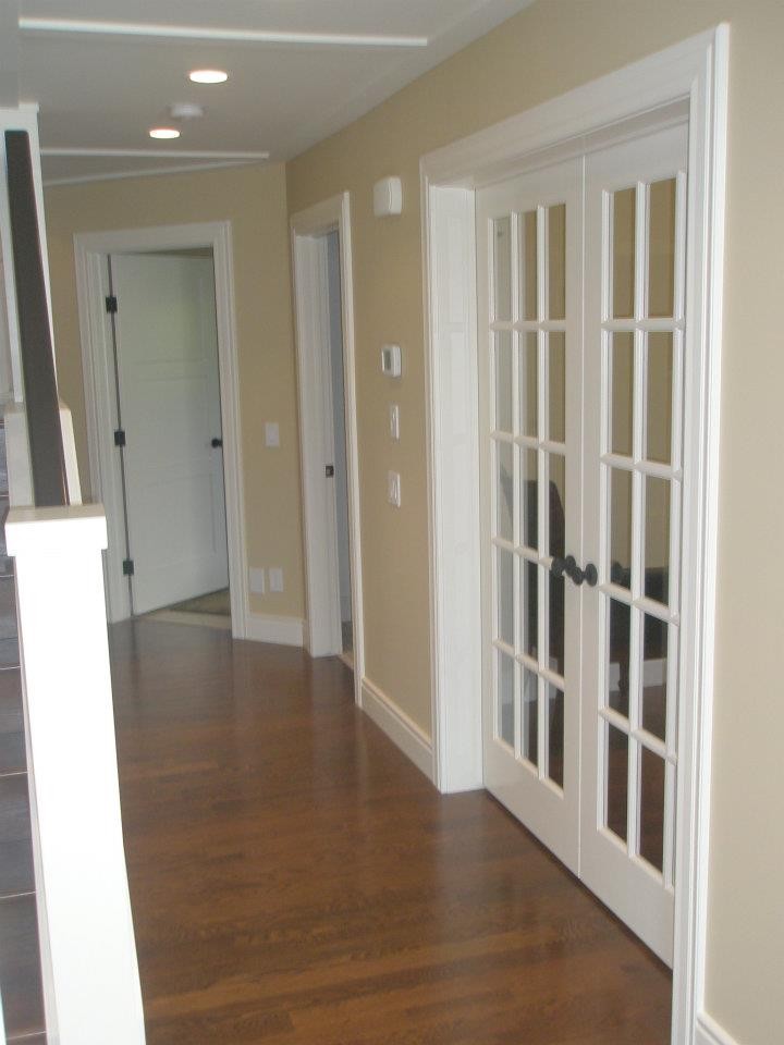Inspiration for a large contemporary medium tone wood floor hallway remodel in Calgary