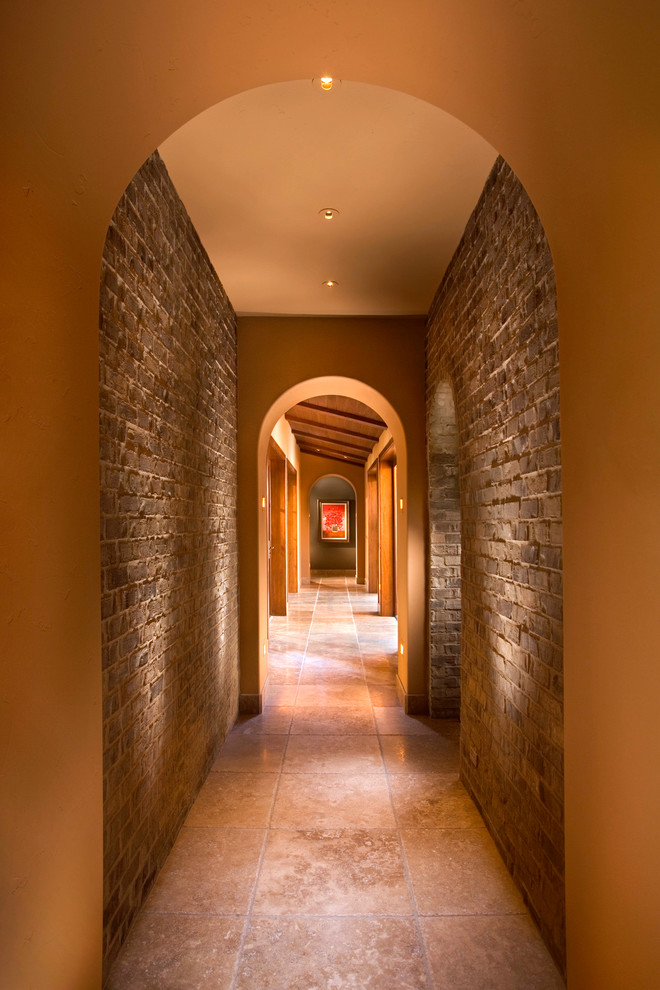 Immagine di un ingresso o corridoio mediterraneo con pareti marroni e pavimento marrone