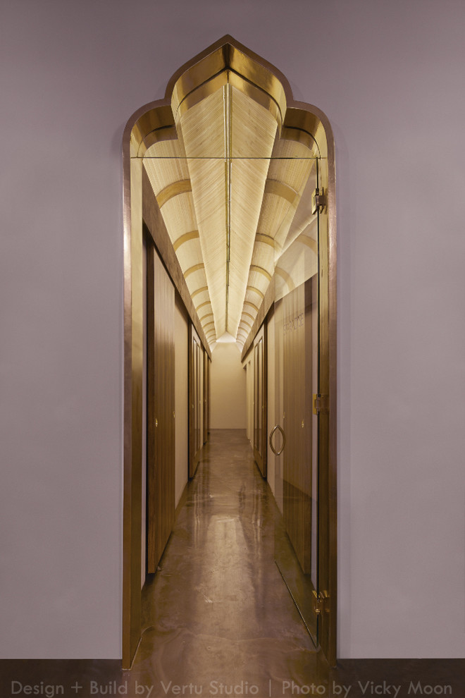 Hallway - small tropical concrete floor hallway idea in Los Angeles with gray walls