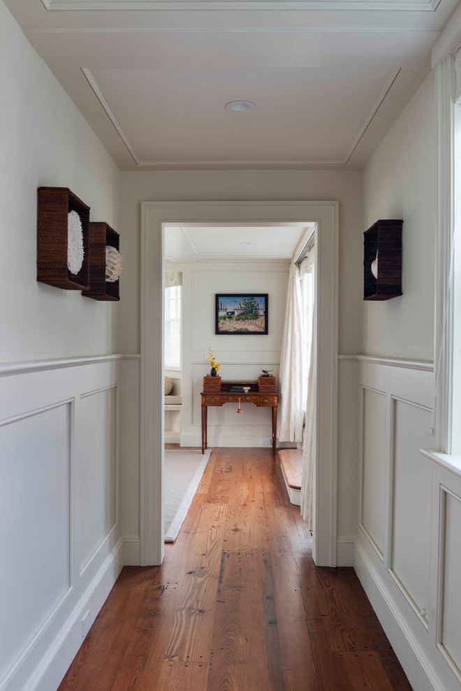 Immagine di un piccolo ingresso o corridoio country con pareti bianche e pavimento in legno massello medio