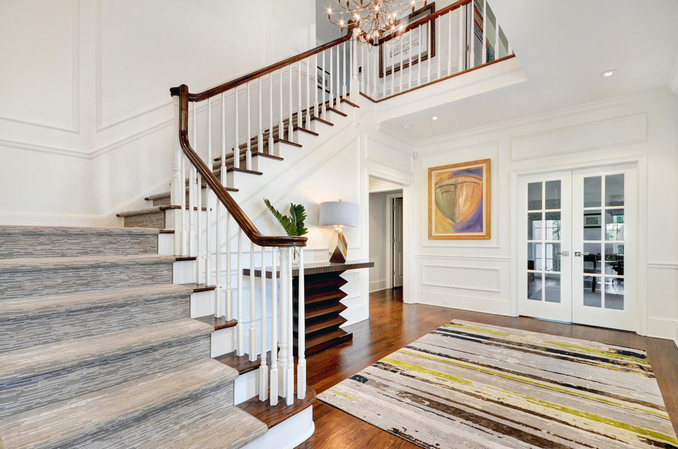 Inspiration for a mid-sized contemporary medium tone wood floor and brown floor hallway remodel in Tampa with white walls