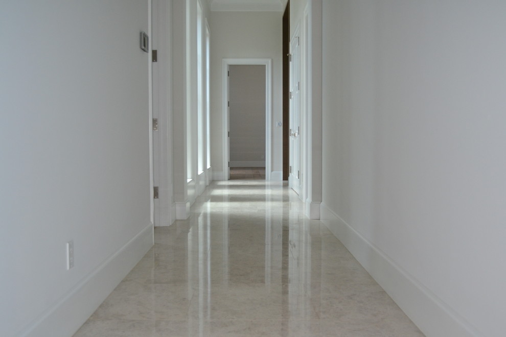Hallway - mid-sized transitional beige floor hallway idea in Miami with white walls