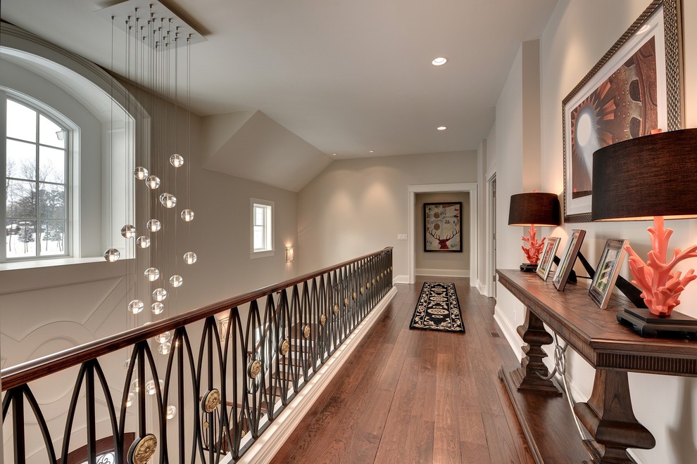 Elegant dark wood floor hallway photo in Minneapolis with white walls