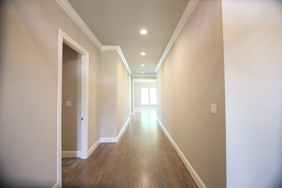 Example of a transitional medium tone wood floor hallway design in Dallas with gray walls