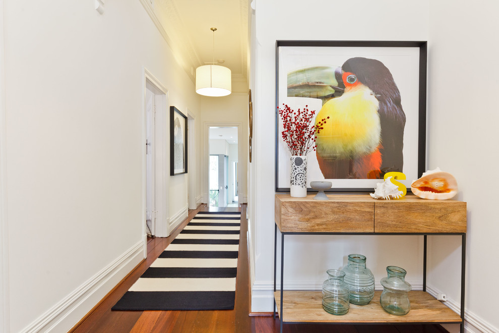 Inspiration for a contemporary medium tone wood floor and brown floor hallway remodel in Other with white walls