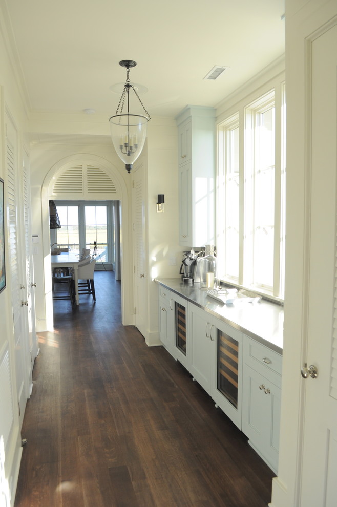 Hallway - coastal dark wood floor hallway idea in Charleston with white walls
