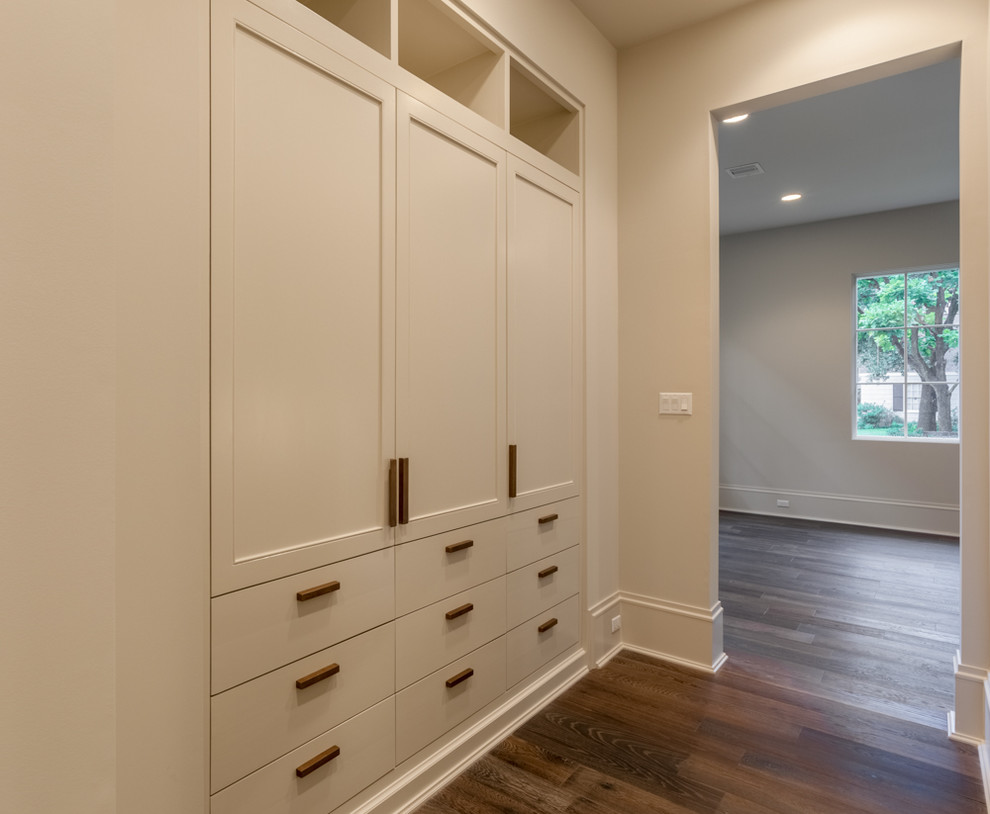 Inspiration for a large transitional dark wood floor hallway remodel in Houston with beige walls