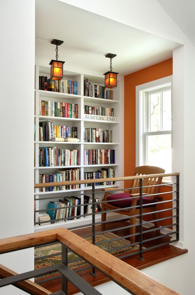 Inspiration for a mid-sized craftsman medium tone wood floor and brown floor hallway remodel in New York with orange walls