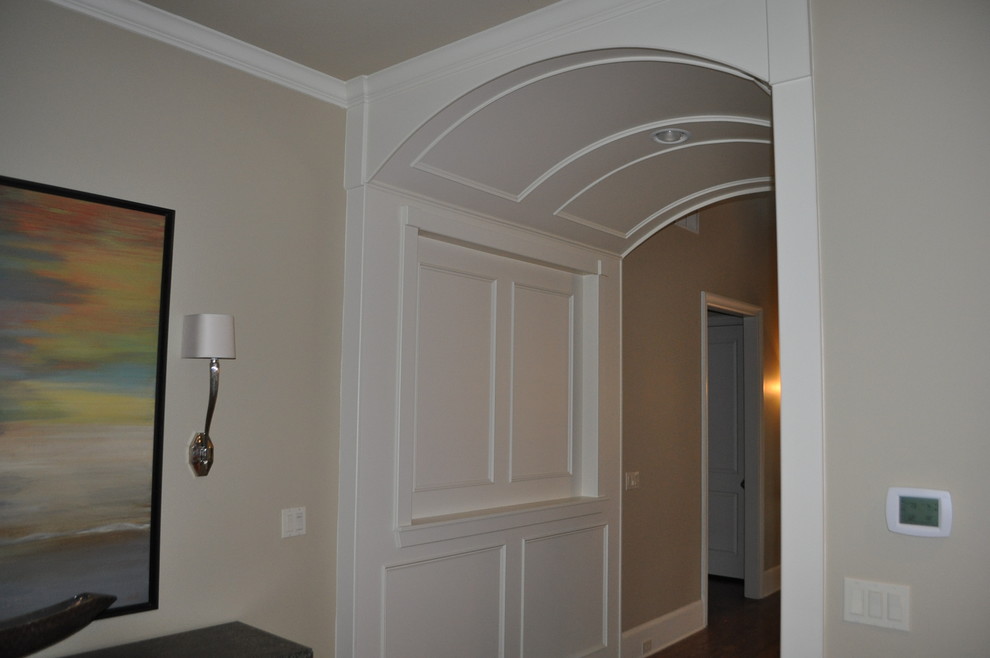 Hallway - mid-sized traditional medium tone wood floor hallway idea in Dallas with beige walls